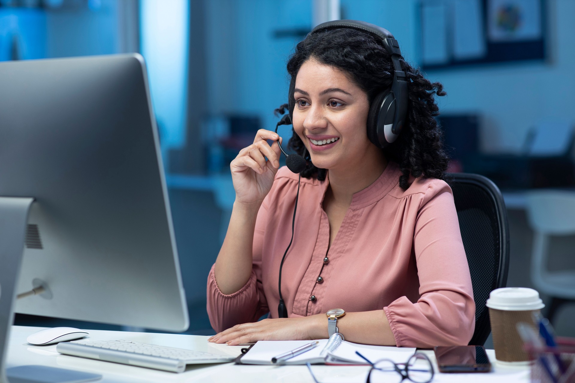 shot of a young female call center agent working in office:- stock photo